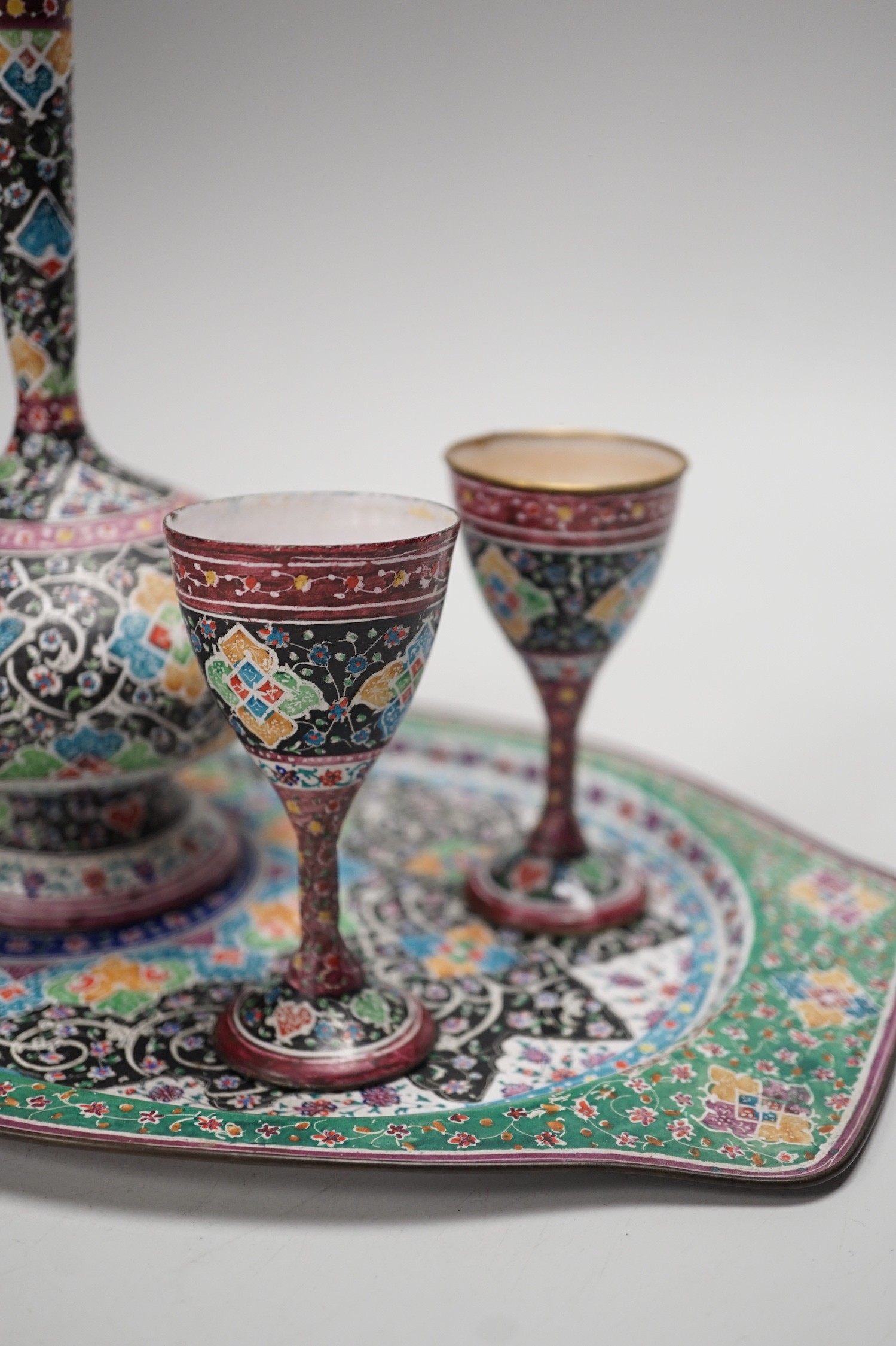 A decorative Persian enamel on copper set on stand. Tallest piece 20cm